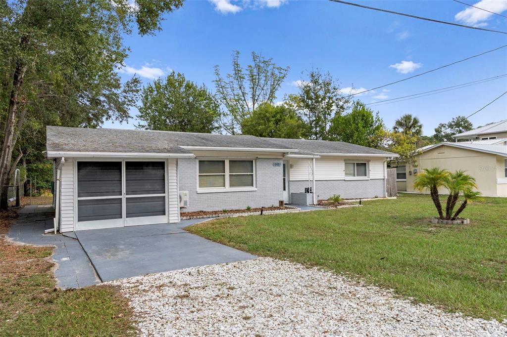 6421 Finance Avenue Weeki Wachee, FL 34607 - Photo 8 of 38 a front view of a house with garden