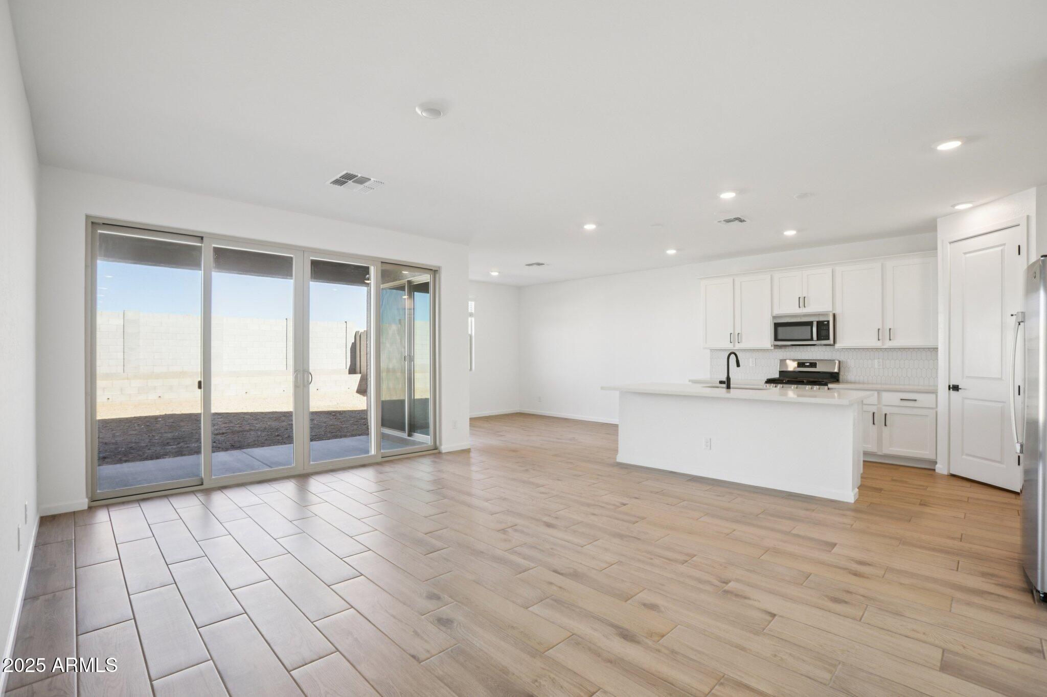 16226 West Bajada Road Surprise, AZ 85387 - Photo 8 of 45 a view of large kitchen with granite countertop lots of counter top space and stainless steel appliances