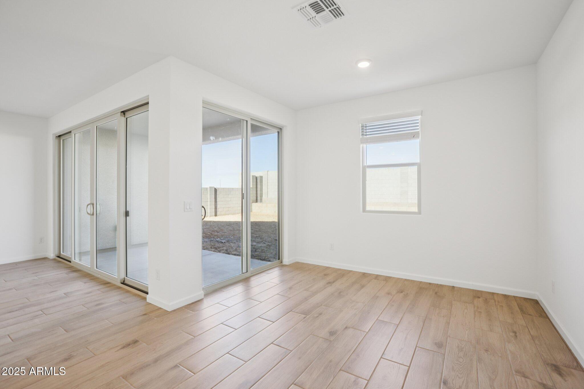 16226 West Bajada Road Surprise, AZ 85387 - Photo 9 of 45 wooden floor in an empty room with a window