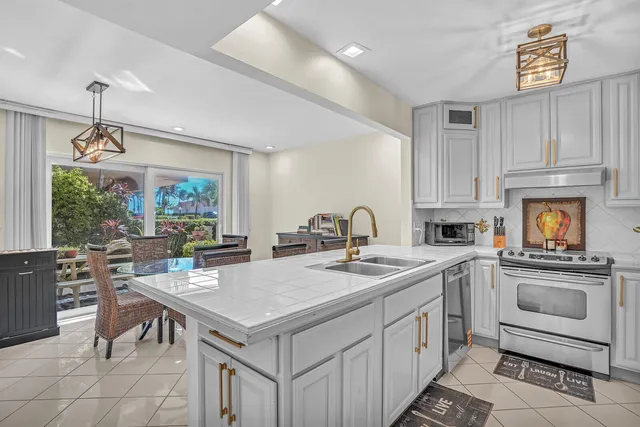 a kitchen with a stove a sink and a refrigerator