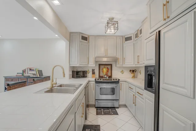a kitchen with cabinets a sink and appliances