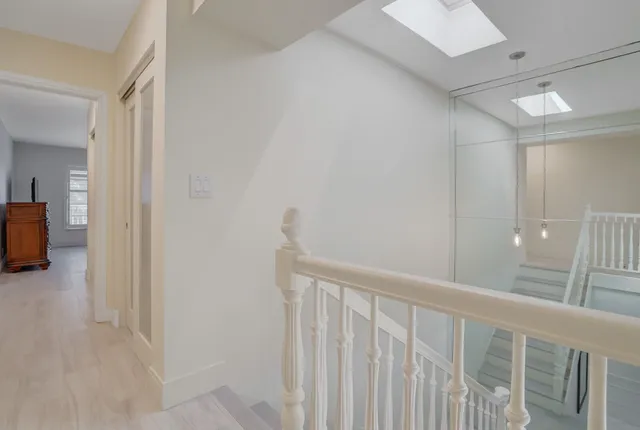 a large bed sitting in a bedroom next to a window