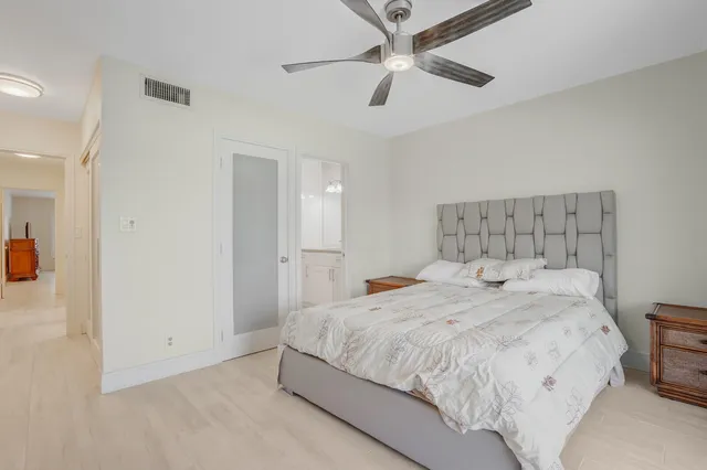 a bathroom with a granite countertop sink a toilet and a mirror