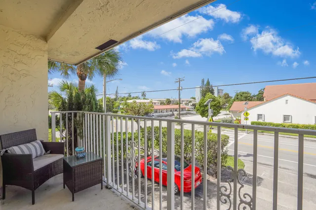 a view of a patio with table and chairs and potted plants