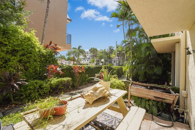 a view of a house with backyard sitting area and garden
