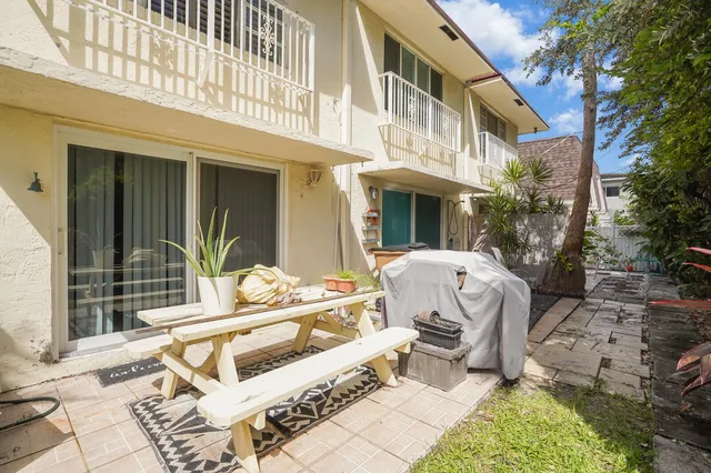 a view of a chair and table in backyard