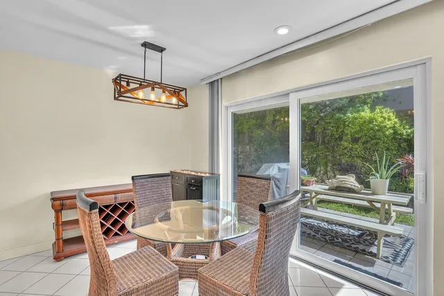 a dining room with wooden floor a chandelier