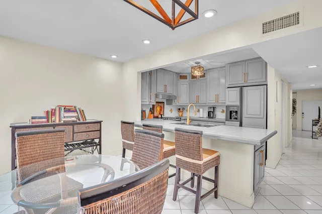 a kitchen with kitchen island a white counter top space and appliances