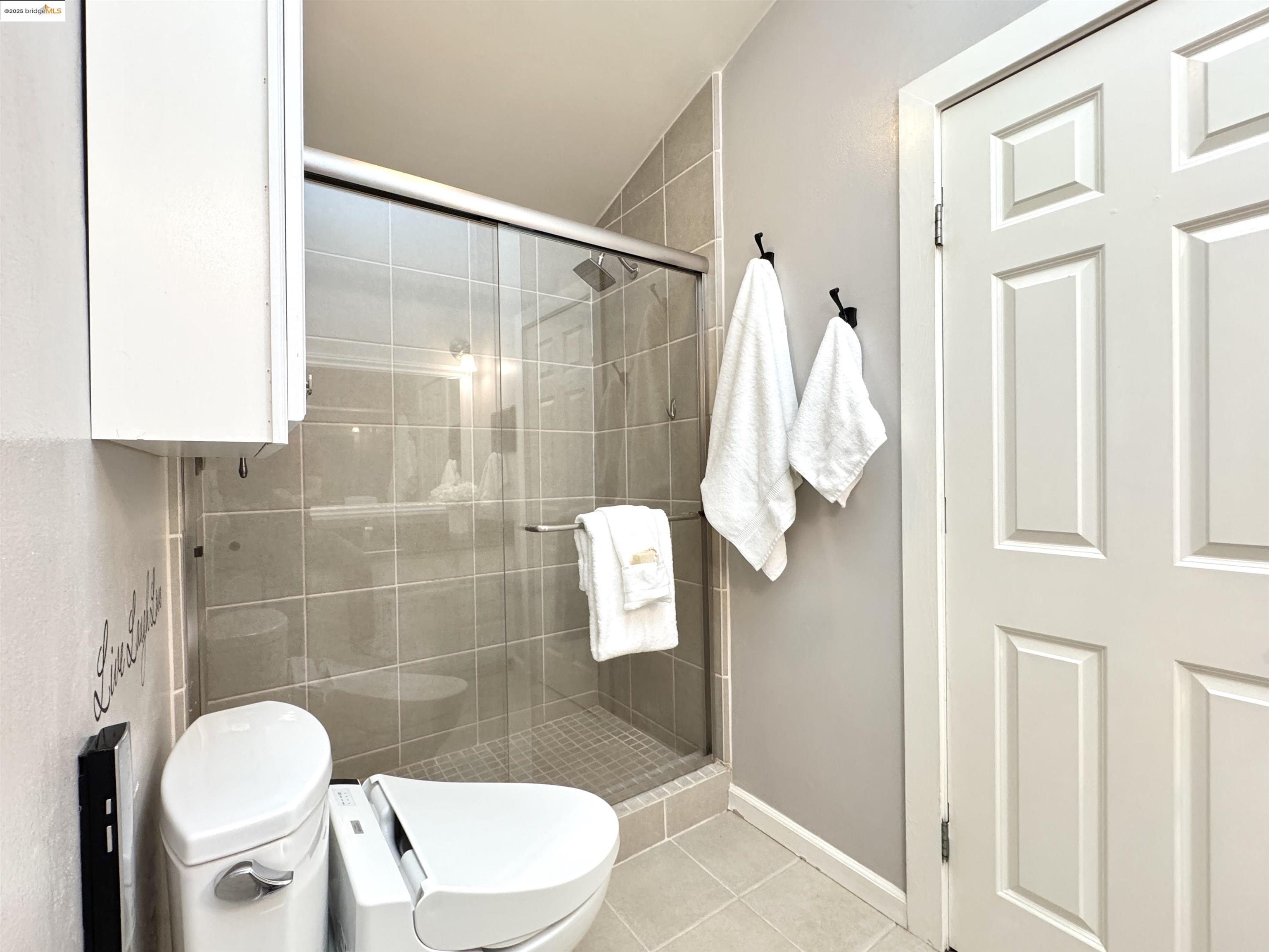 3365 Los Prados Street San Mateo, CA 94403 - Photo 25 of 47 a bathroom with a shower toilet and sink