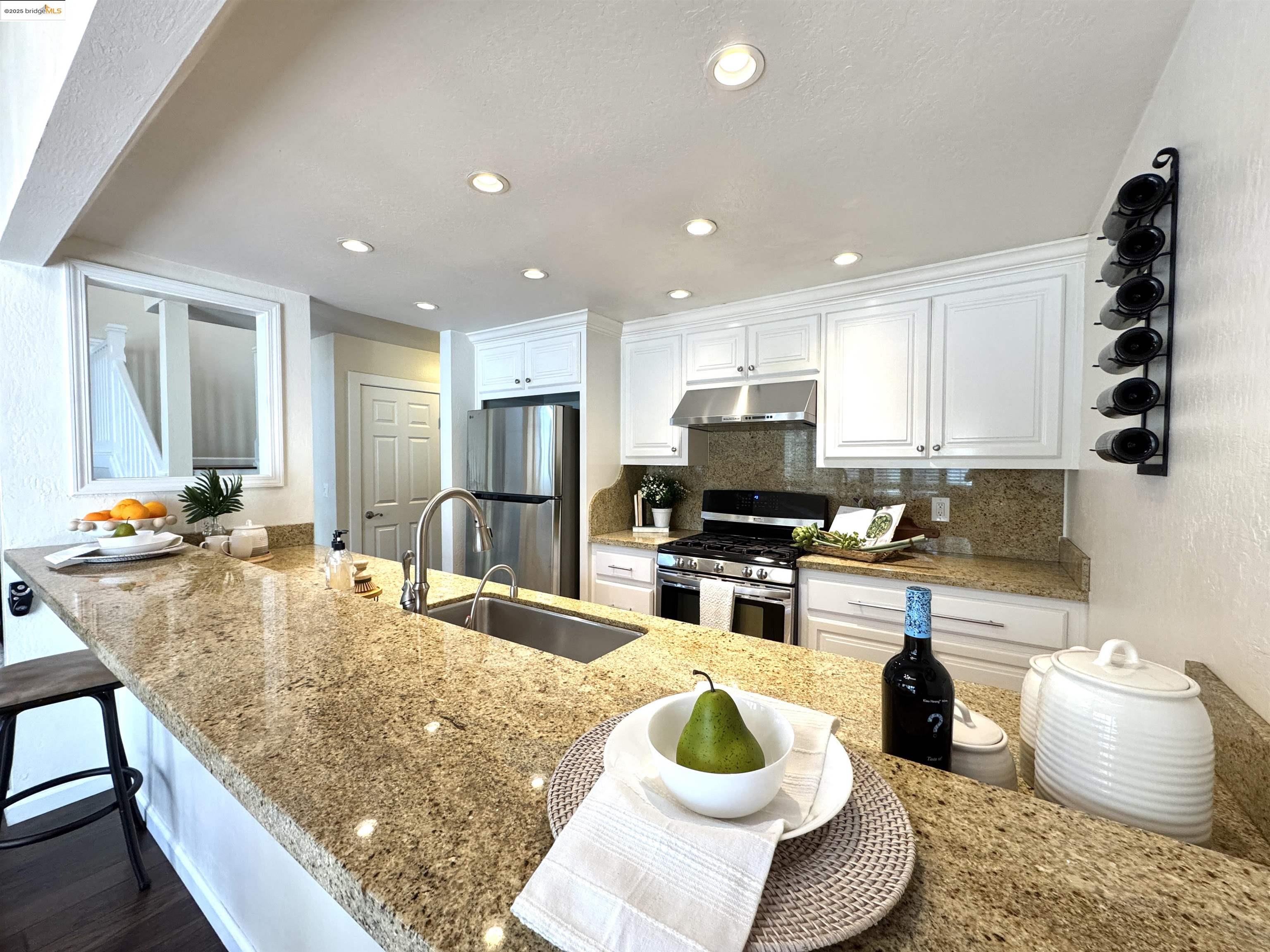 3365 Los Prados Street San Mateo, CA 94403 - Photo 9 of 47 a kitchen with sink a refrigerator and chairs