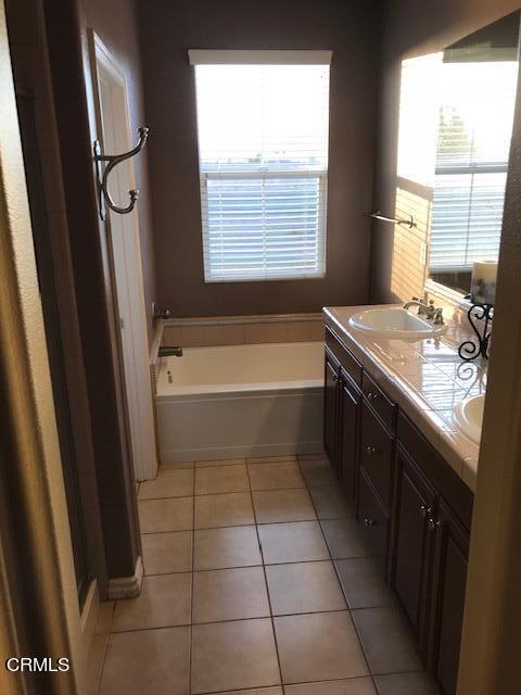 4635 Via Del Sol Camarillo, CA 93012 - Photo 13 of 16 a bathroom with a tub sink and mirror