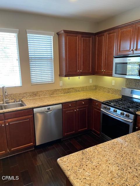 4635 Via Del Sol Camarillo, CA 93012 - Photo 3 of 16 a kitchen with granite countertop wooden cabinets stainless steel appliances and a window