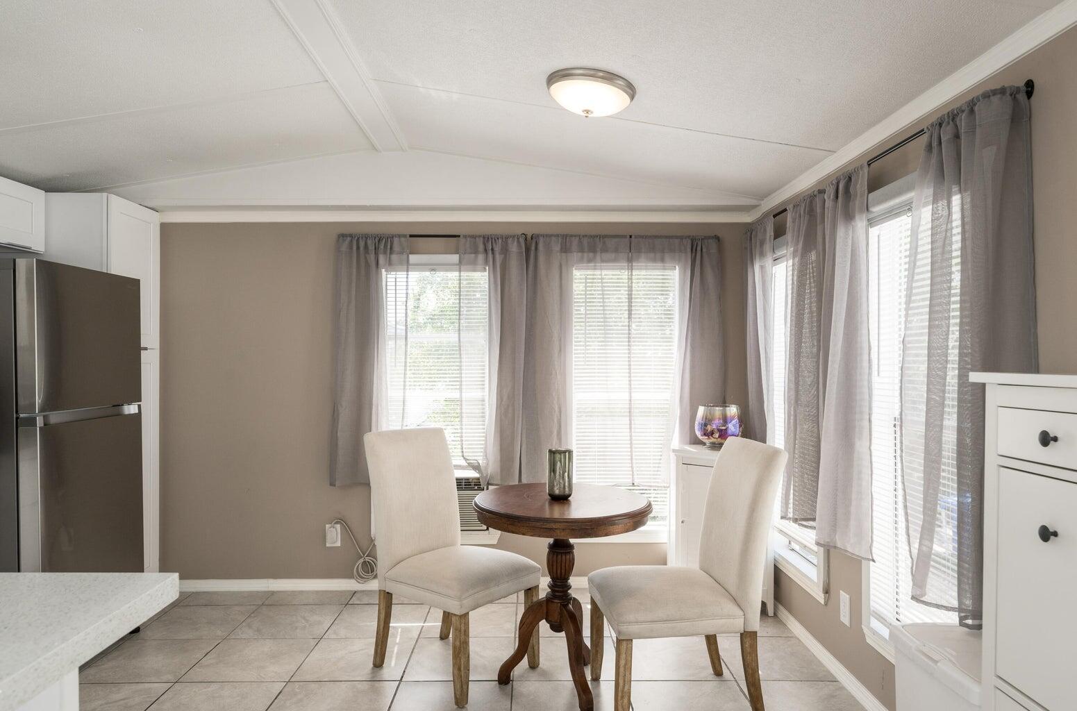 27942 Snapper Lane Summerland Key, FL 33042 - Photo 10 of 26 a view of a dining room with furniture and windows