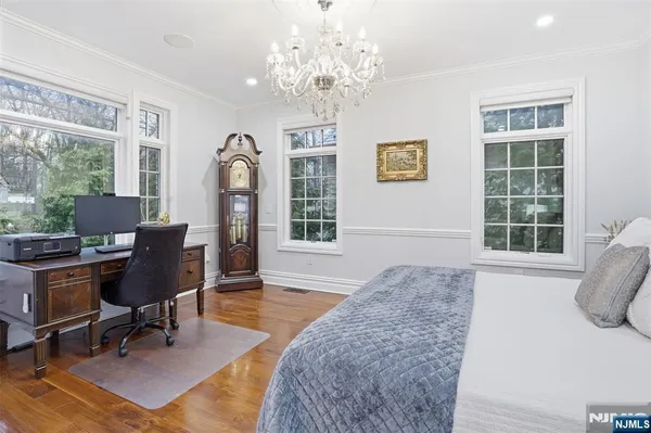 a spacious bedroom with a bed and a large window
