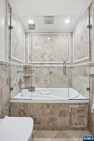 a bathroom with a shower sink and mirror