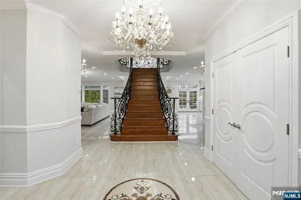 a view of entryway and hall with wooden floor
