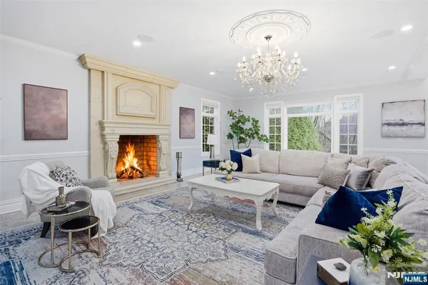 a view of a dining room with furniture and a chandelier