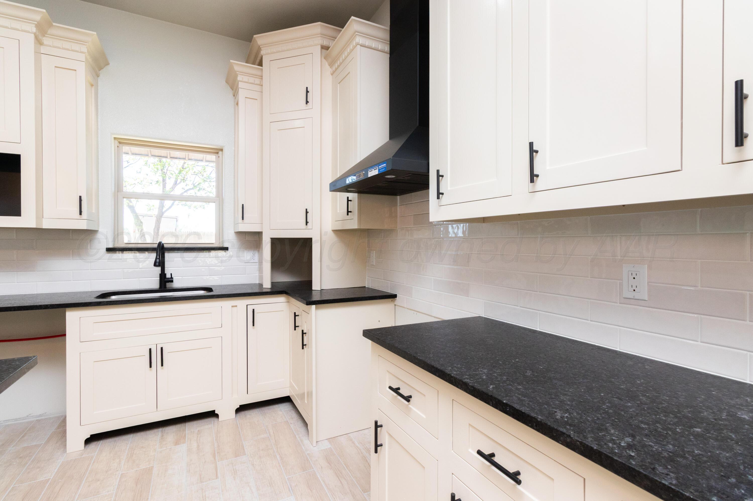 810 South Houston Street Shamrock, TX 79079 - Photo 11 of 42 a kitchen with stainless steel appliances granite countertop a sink and a white cabinets