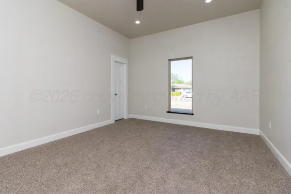an empty room with windows and closet