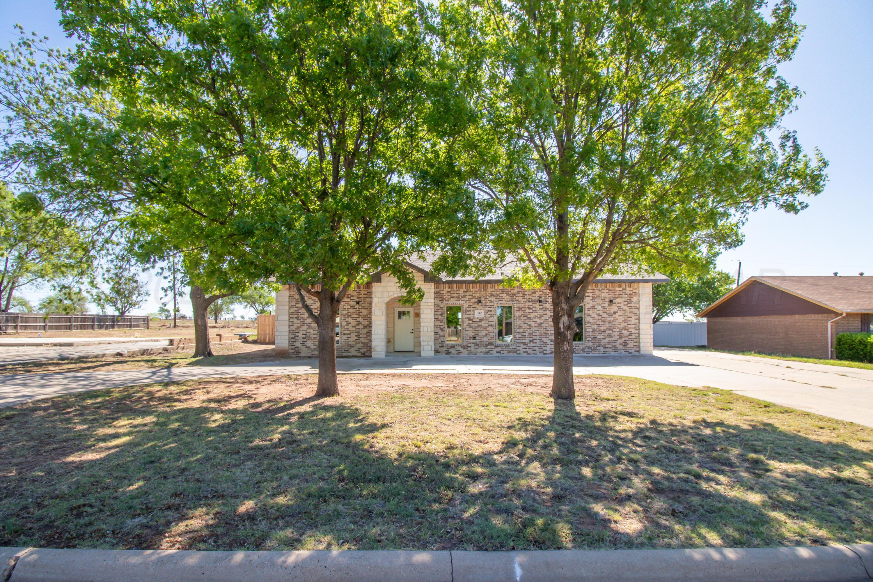 810 South Houston Street Shamrock, TX 79079 - Photo 2 of 42 a house with trees in front of it