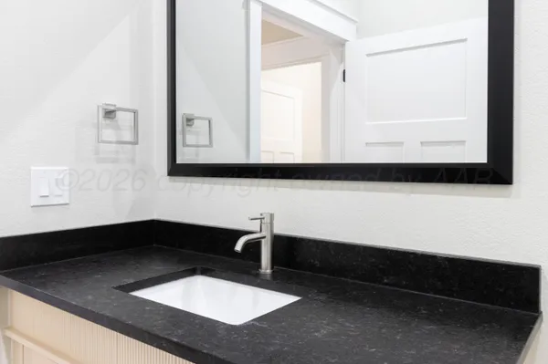 a bathroom with a sink and a mirror