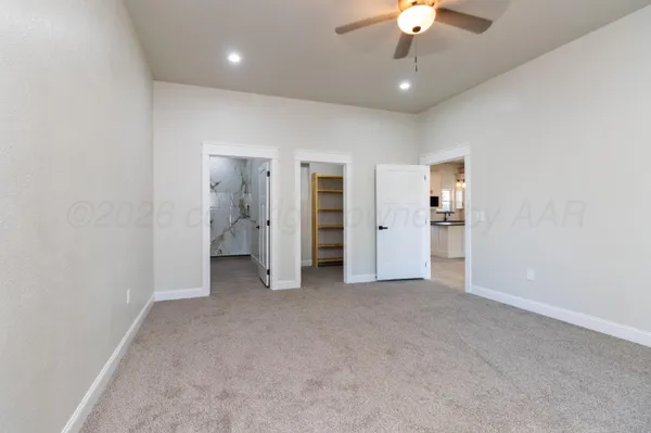 wooden floor in an empty room with a bathroom