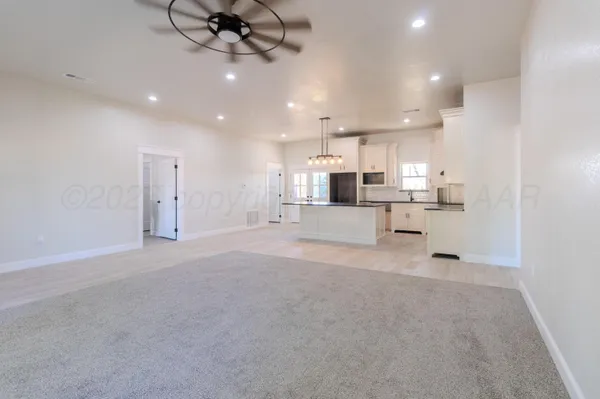 a view of a kitchen with a sink and a refrigerator