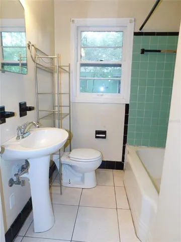 a bathroom with a sink toilet and tub