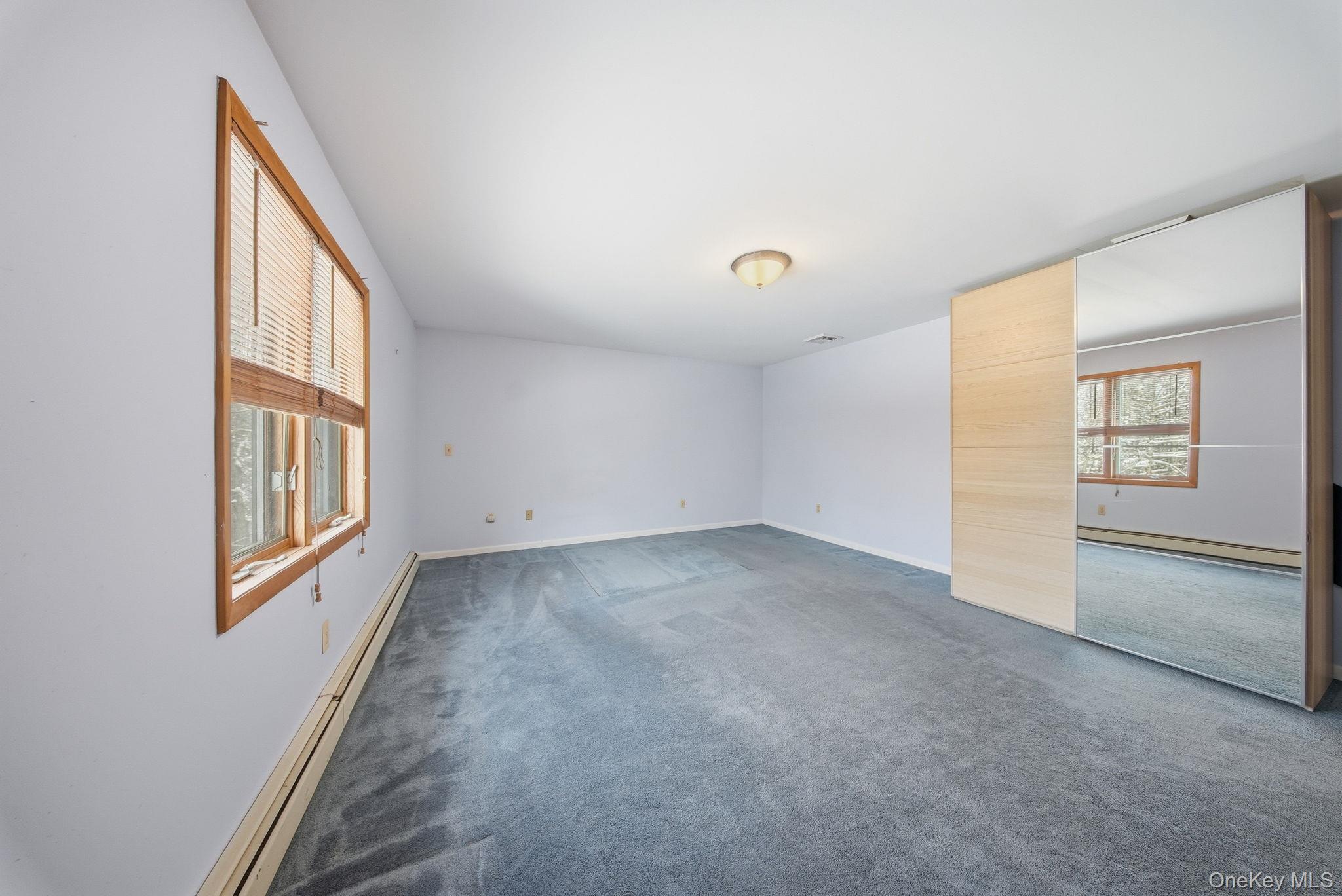 139 Renner Road Mountain Dale, NY 12763 - Photo 22 of 50 an empty room with windows