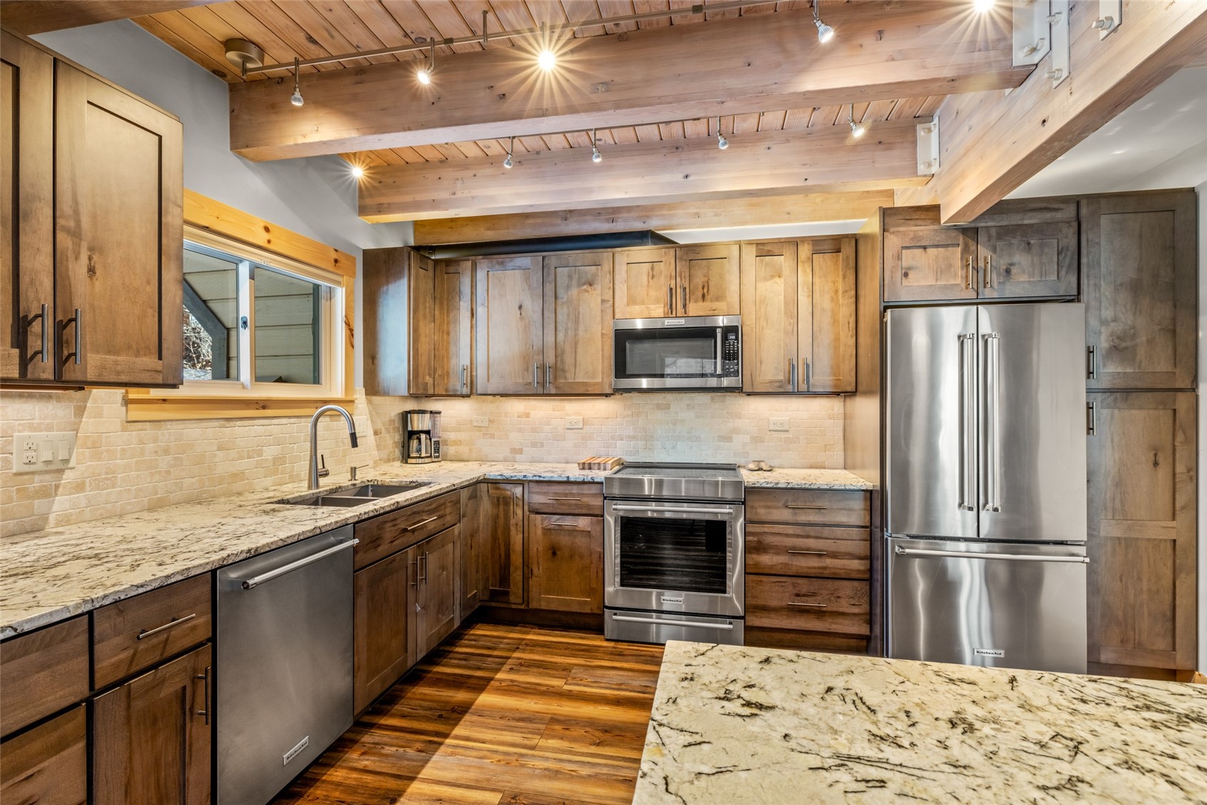 2650 Medicine Springs Road, Unit 11 Steamboat Springs, CO 80487 - Photo 11 of 40 a kitchen with stainless steel appliances granite countertop a sink stove and refrigerator