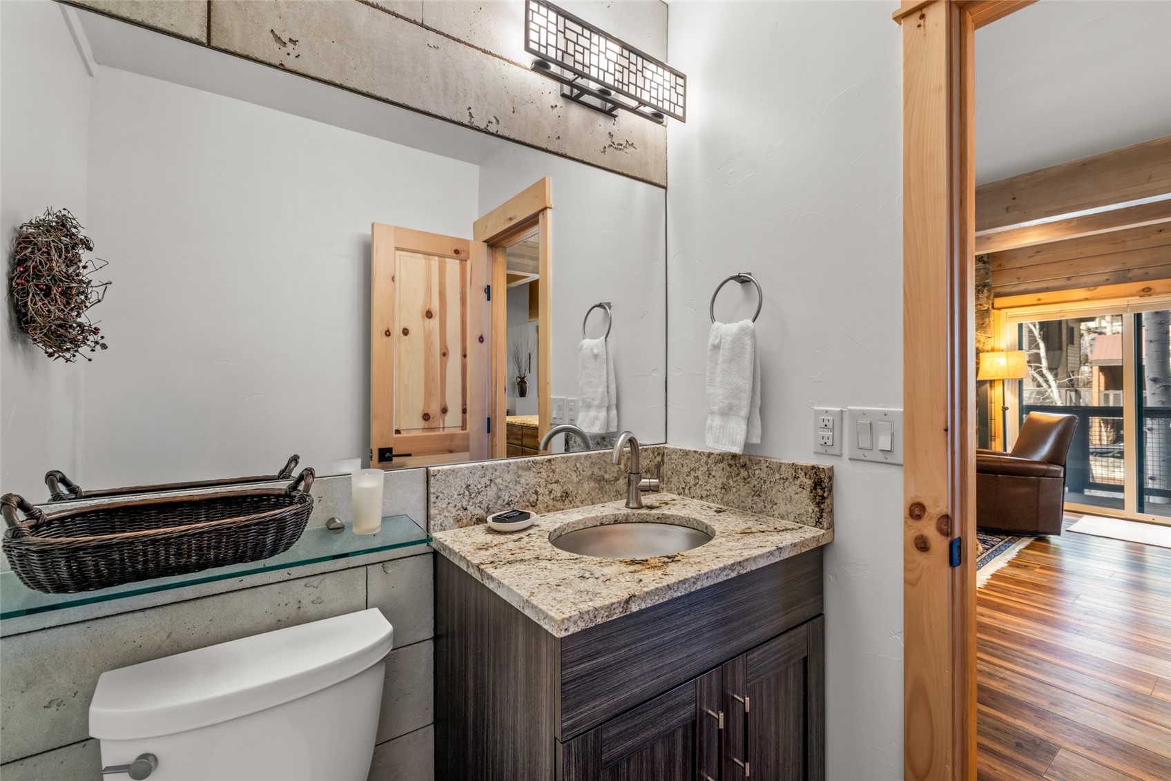 2650 Medicine Springs Road, Unit 11 Steamboat Springs, CO 80487 - Photo 12 of 40 a bathroom with a granite countertop sink a toilet and a mirror