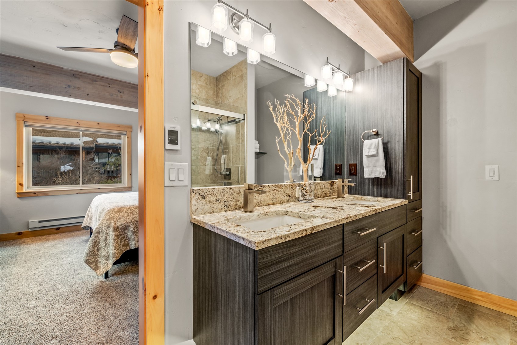 2650 Medicine Springs Road, Unit 11 Steamboat Springs, CO 80487 - Photo 18 of 40 a en suite bathroom with a granite countertop sink and a mirror
