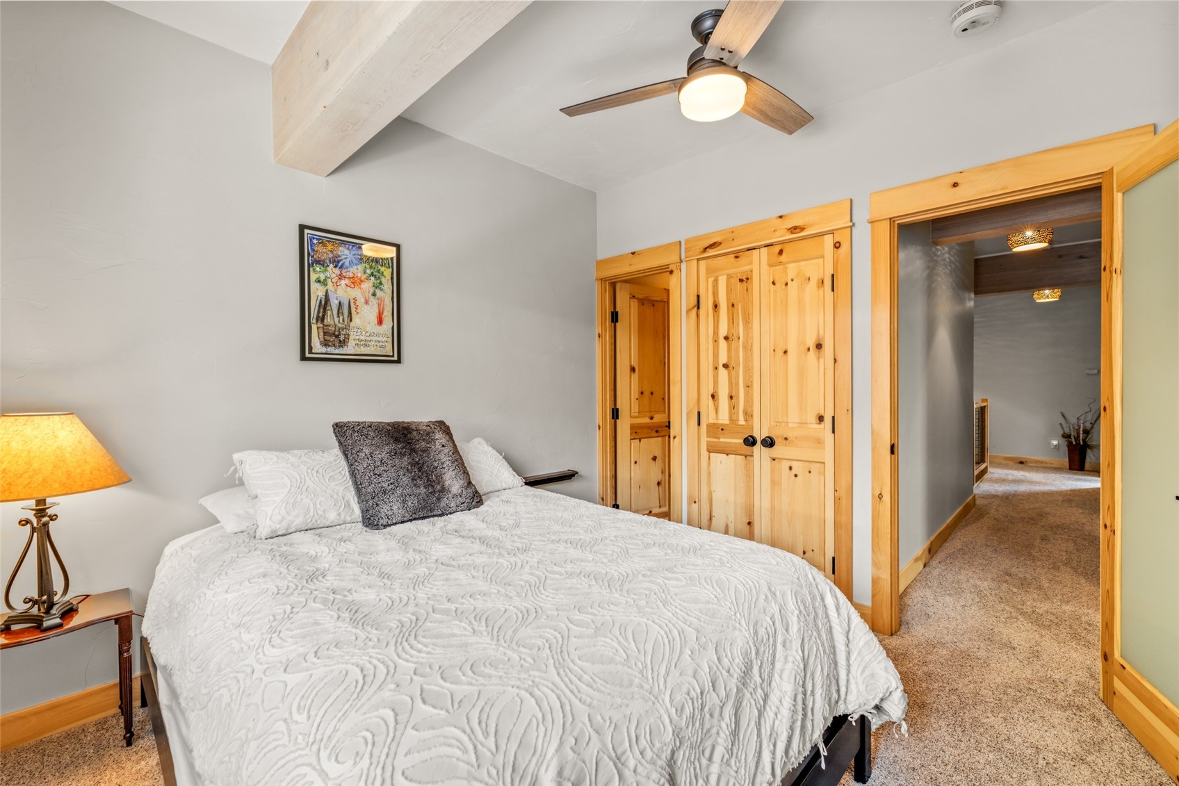 2650 Medicine Springs Road, Unit 11 Steamboat Springs, CO 80487 - Photo 21 of 40 a bedroom with a bed and a lamp on dresser