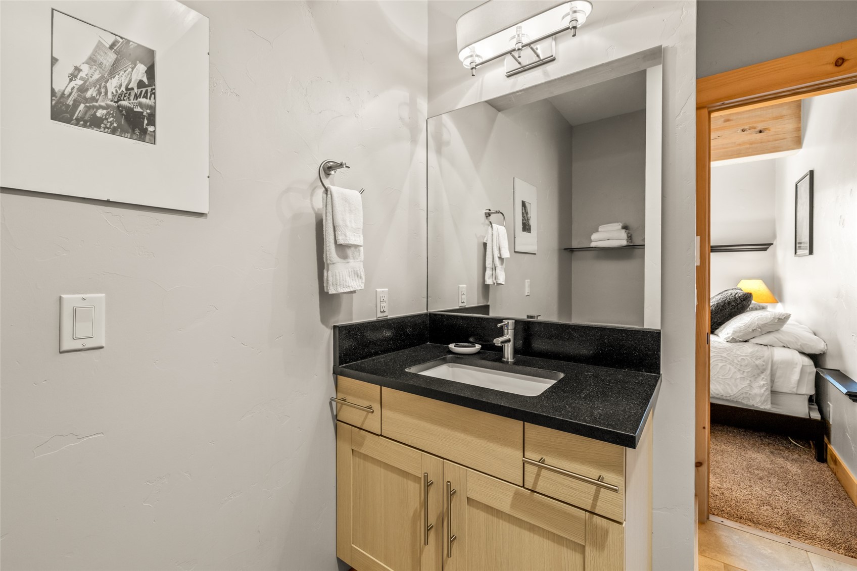 2650 Medicine Springs Road, Unit 11 Steamboat Springs, CO 80487 - Photo 22 of 40 a bathroom with a granite countertop sink and a mirror