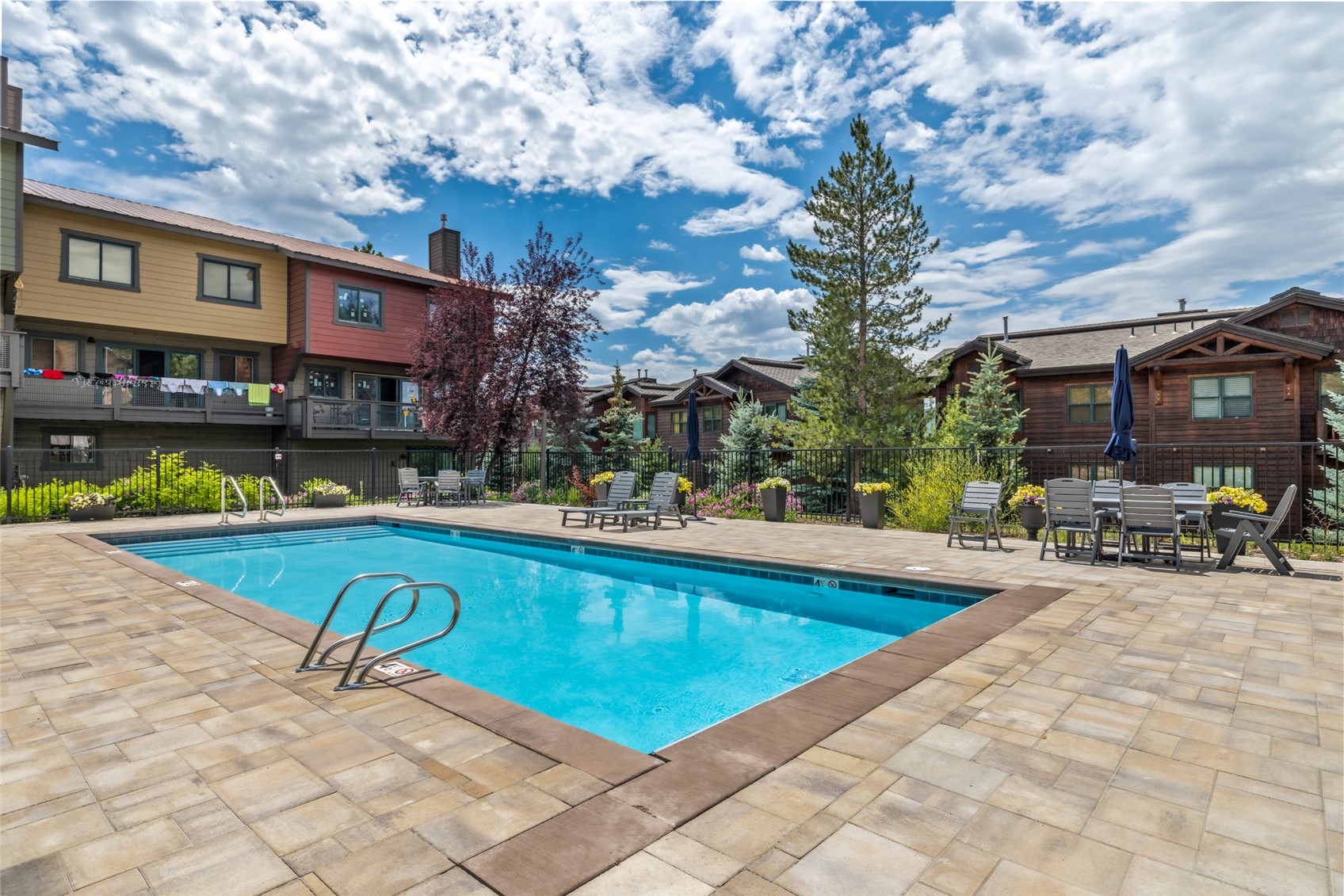 2650 Medicine Springs Road, Unit 11 Steamboat Springs, CO 80487 - Photo 32 of 40 a view of swimming pool with outdoor seating and a trees in the background