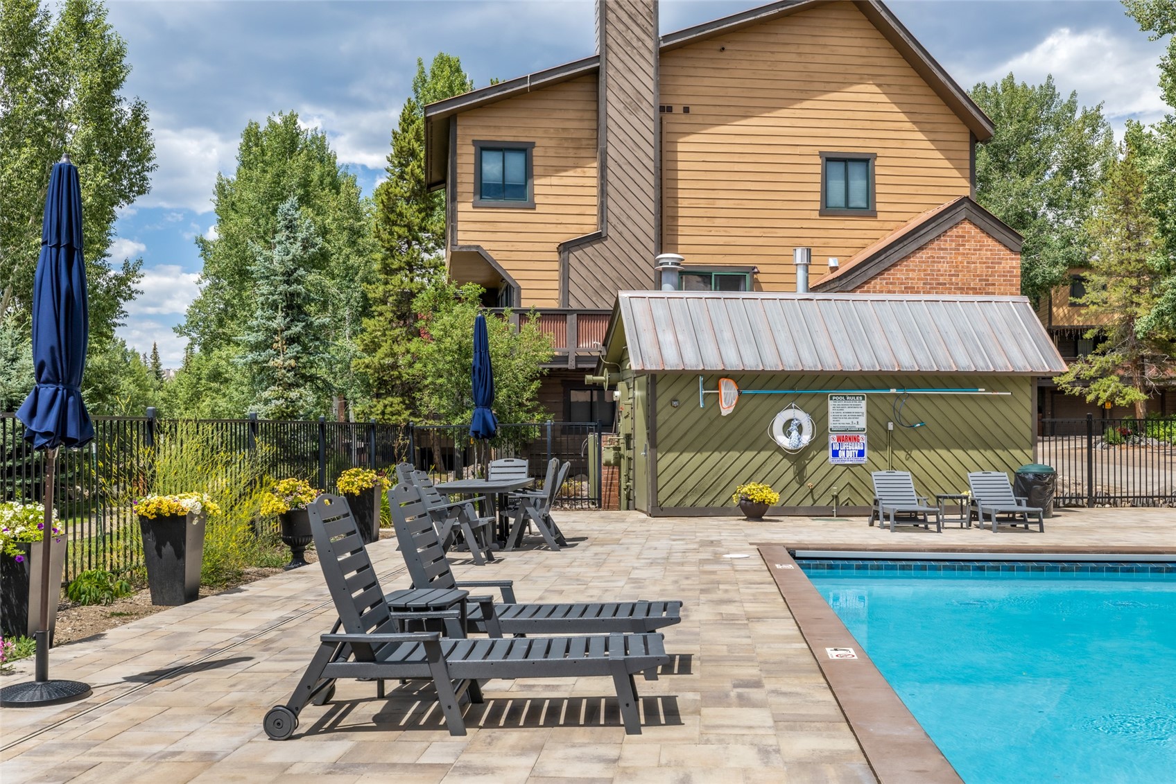 2650 Medicine Springs Road, Unit 11 Steamboat Springs, CO 80487 - Photo 33 of 40 a view of a patio with table and chairs potted plants and a large tree