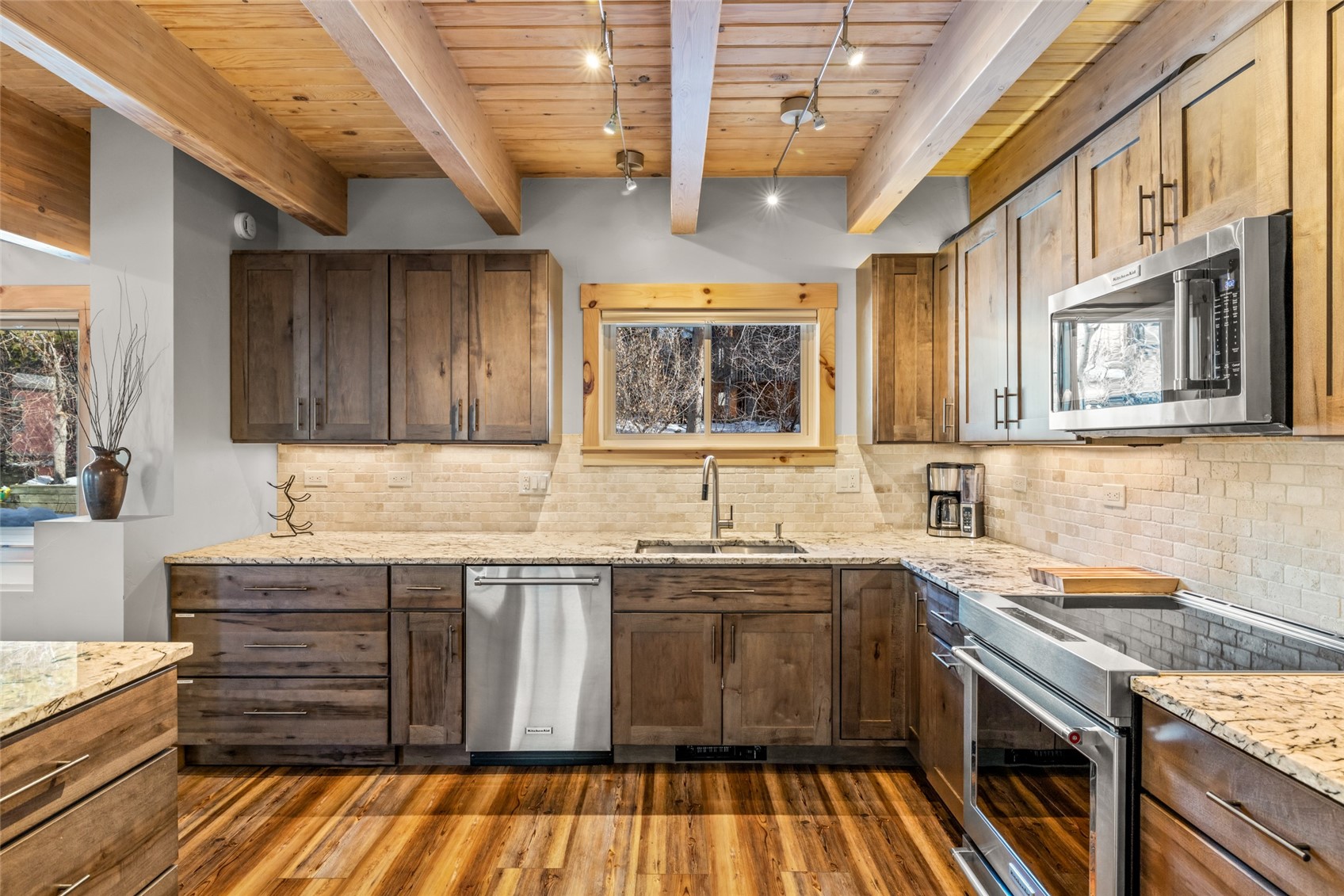2650 Medicine Springs Road, Unit 11 Steamboat Springs, CO 80487 - Photo 4 of 40 a kitchen with a sink stove and cabinets