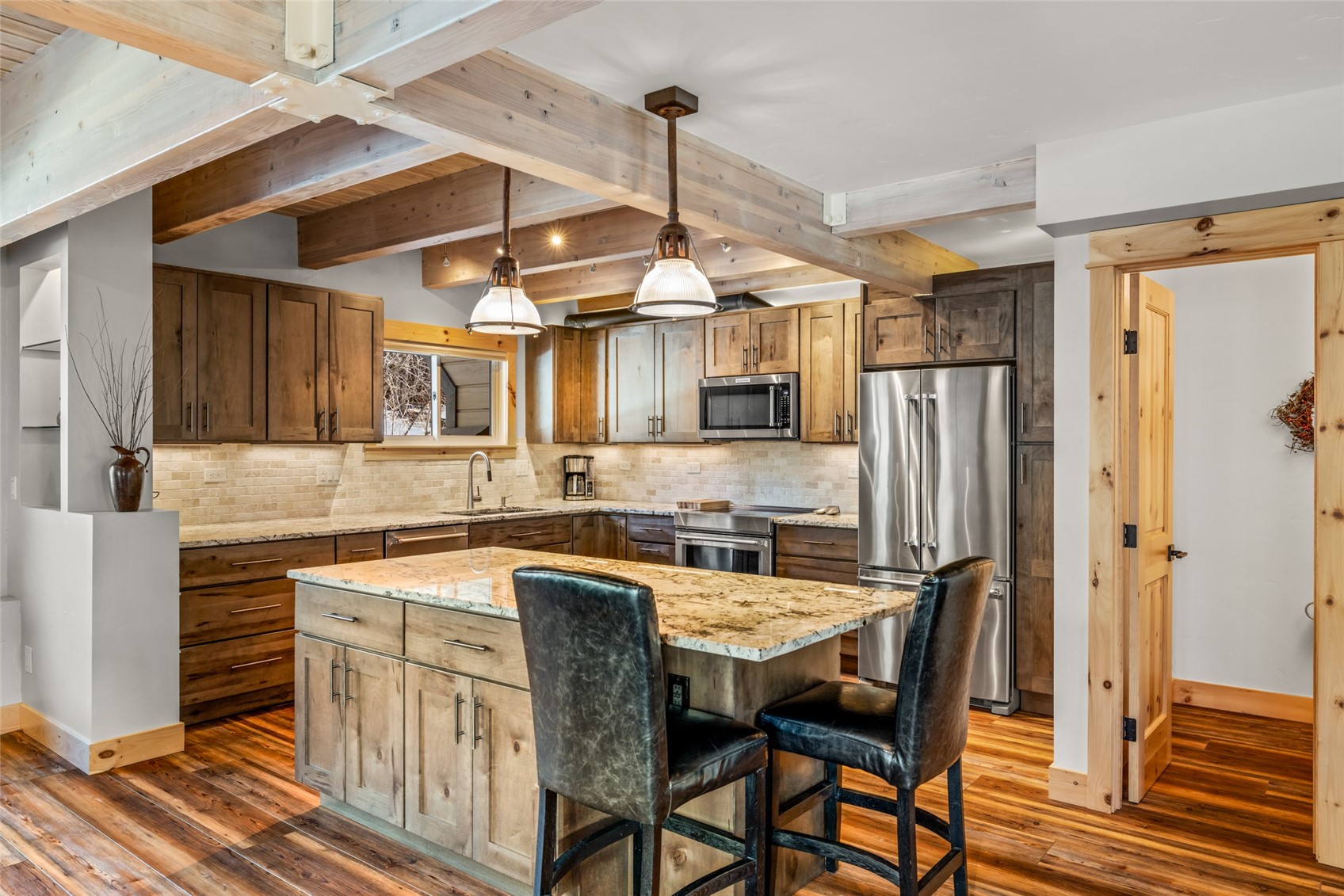 2650 Medicine Springs Road, Unit 11 Steamboat Springs, CO 80487 - Photo 5 of 40 a kitchen with stainless steel appliances granite countertop a sink refrigerator and cabinets
