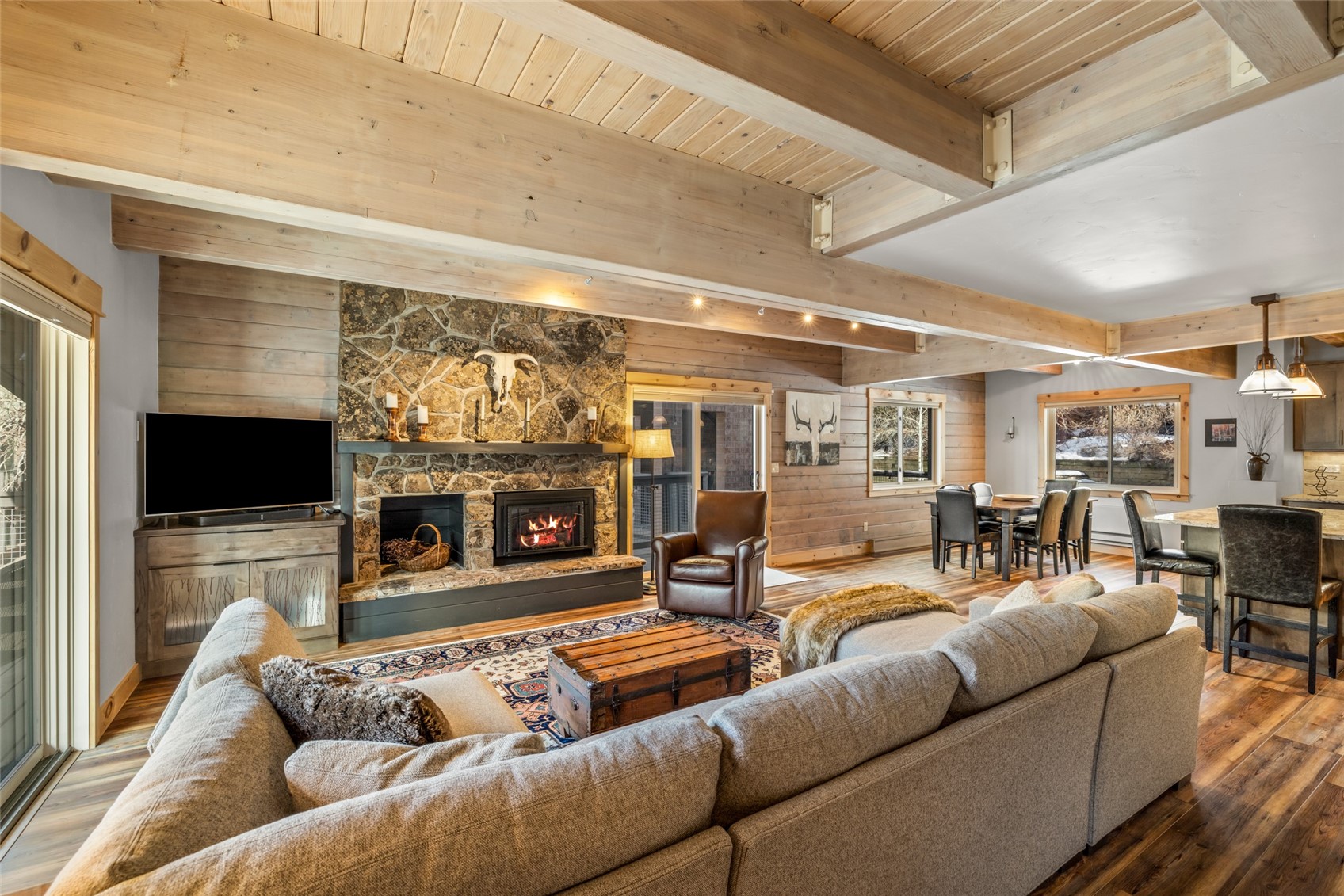 2650 Medicine Springs Road, Unit 11 Steamboat Springs, CO 80487 - Photo 7 of 40 a living room with furniture a flat screen tv and a fireplace