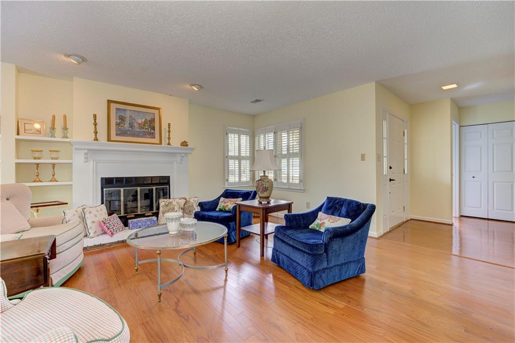 94 Robyn Way Marietta, GA 30062 - Photo 11 of 40 a living room with furniture wooden floor and a fireplace