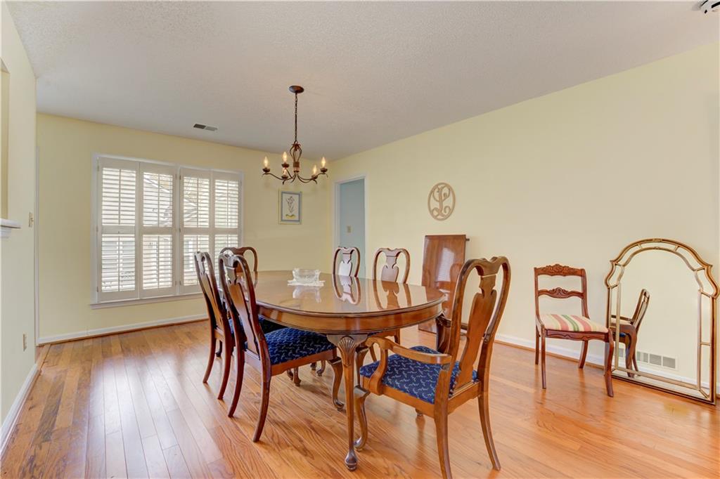 94 Robyn Way Marietta, GA 30062 - Photo 13 of 40 a view of a dining room with furniture window and wooden floor