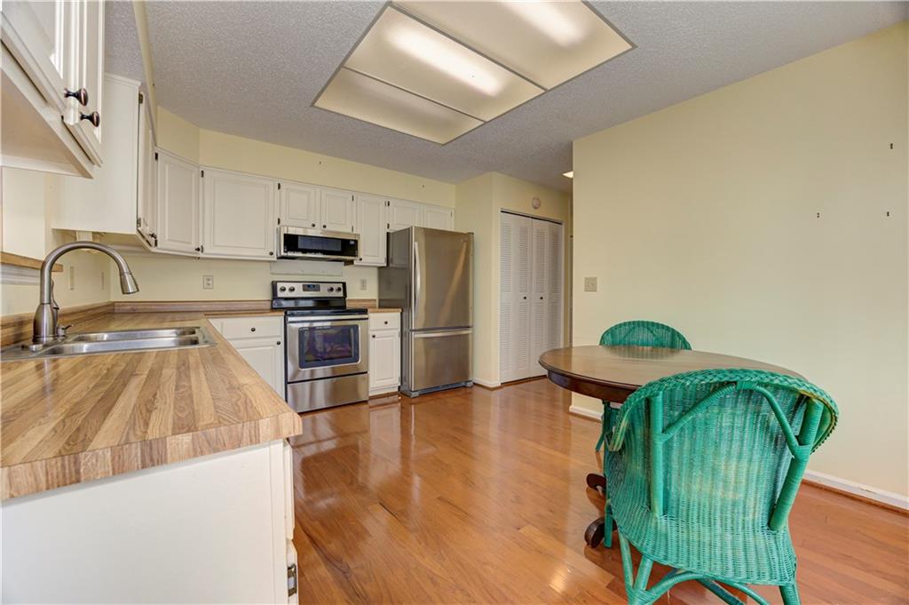 94 Robyn Way Marietta, GA 30062 - Photo 15 of 40 a kitchen with granite countertop stainless steel appliances a sink a counter top space and cabinets