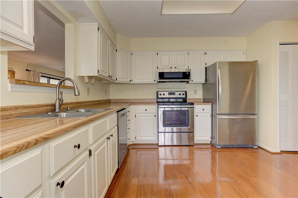 94 Robyn Way Marietta, GA 30062 - Photo 18 of 40 a kitchen with stainless steel appliances a refrigerator stove and sink