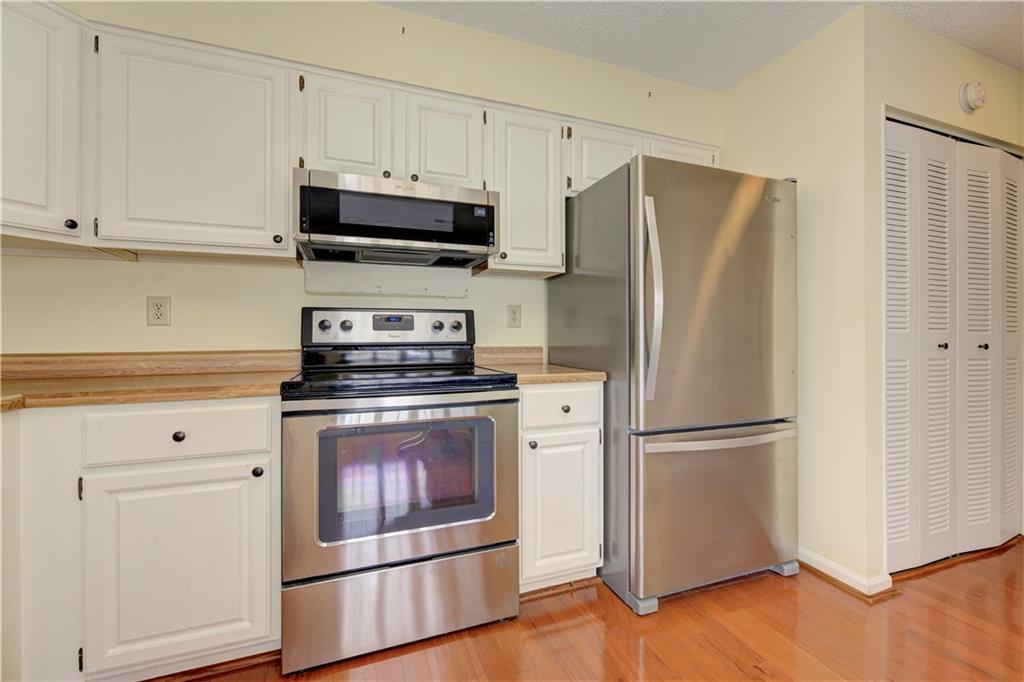 94 Robyn Way Marietta, GA 30062 - Photo 20 of 40 a kitchen with stainless steel appliances white cabinets white stove a refrigerator and a microwave