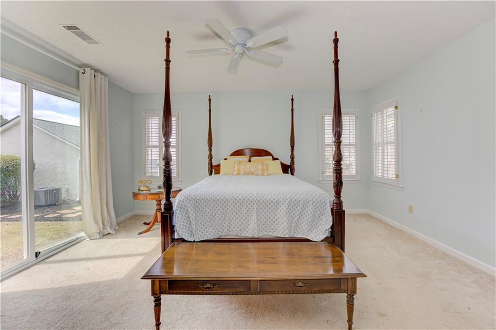 94 Robyn Way Marietta, GA 30062 - Photo 24 of 40 a room with a bed window and a chandelier