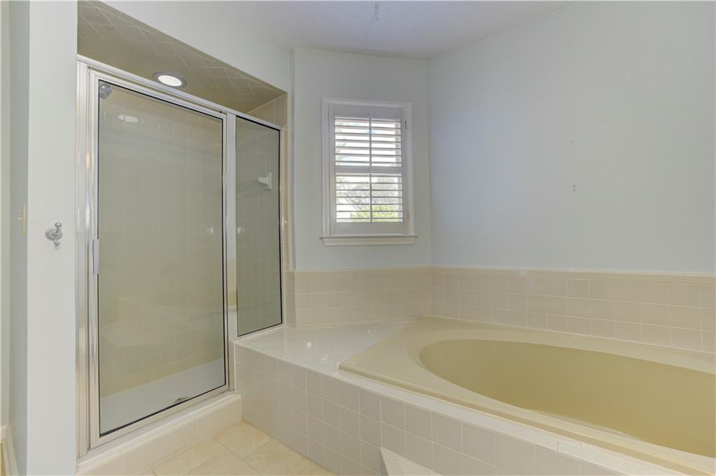 94 Robyn Way Marietta, GA 30062 - Photo 28 of 40 a bathroom with a bathtub and a shower