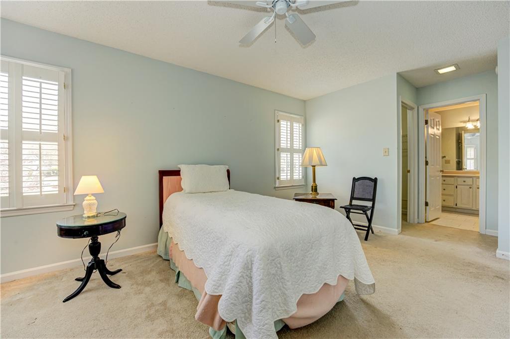 94 Robyn Way Marietta, GA 30062 - Photo 30 of 40 a bedroom with a bed and a chandelier