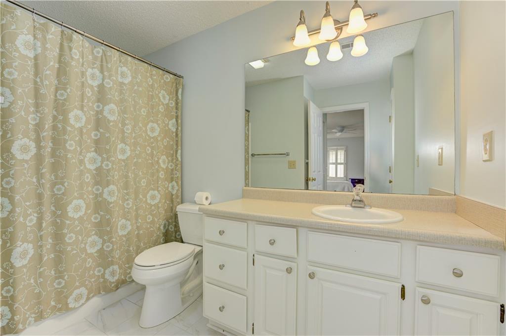94 Robyn Way Marietta, GA 30062 - Photo 33 of 40 a bathroom with a granite countertop sink a toilet and a mirror