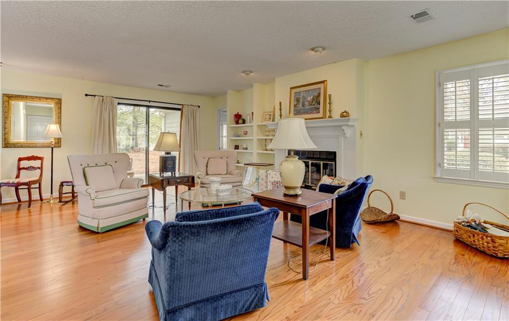 94 Robyn Way Marietta, GA 30062 - Photo 7 of 40 a living room with fireplace furniture and a wooden floor