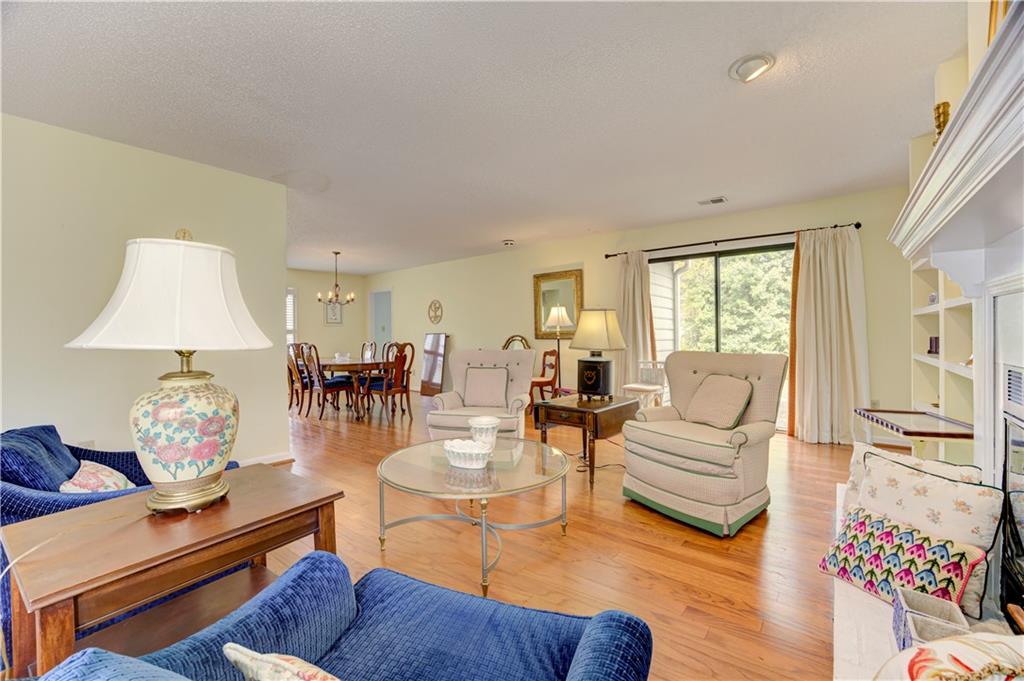 94 Robyn Way Marietta, GA 30062 - Photo 10 of 40 a living room with furniture or couch and a dining table with wooden floor